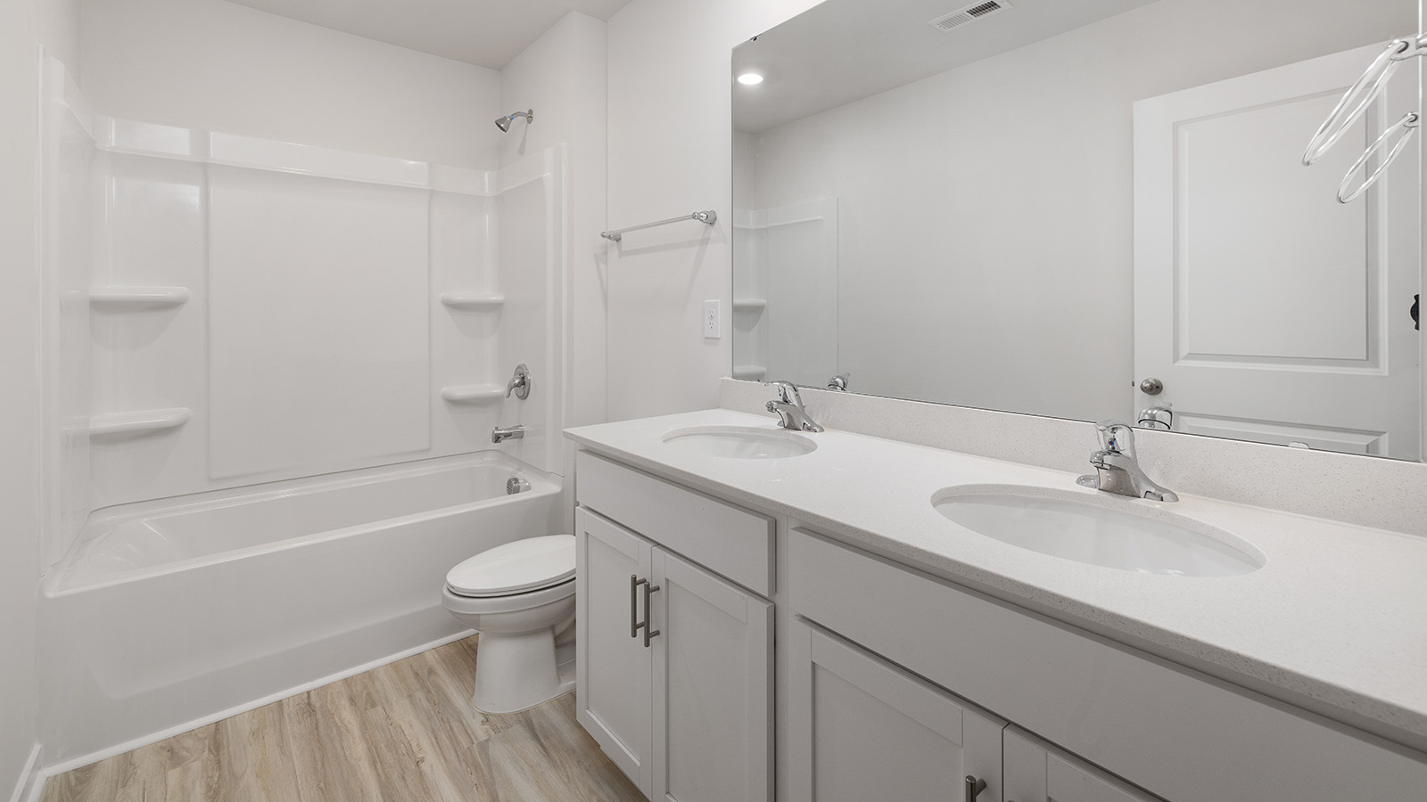 Bathroom with double sinks and bathtub