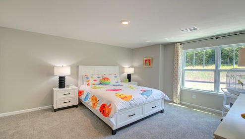 Carpeted bedroom with large window