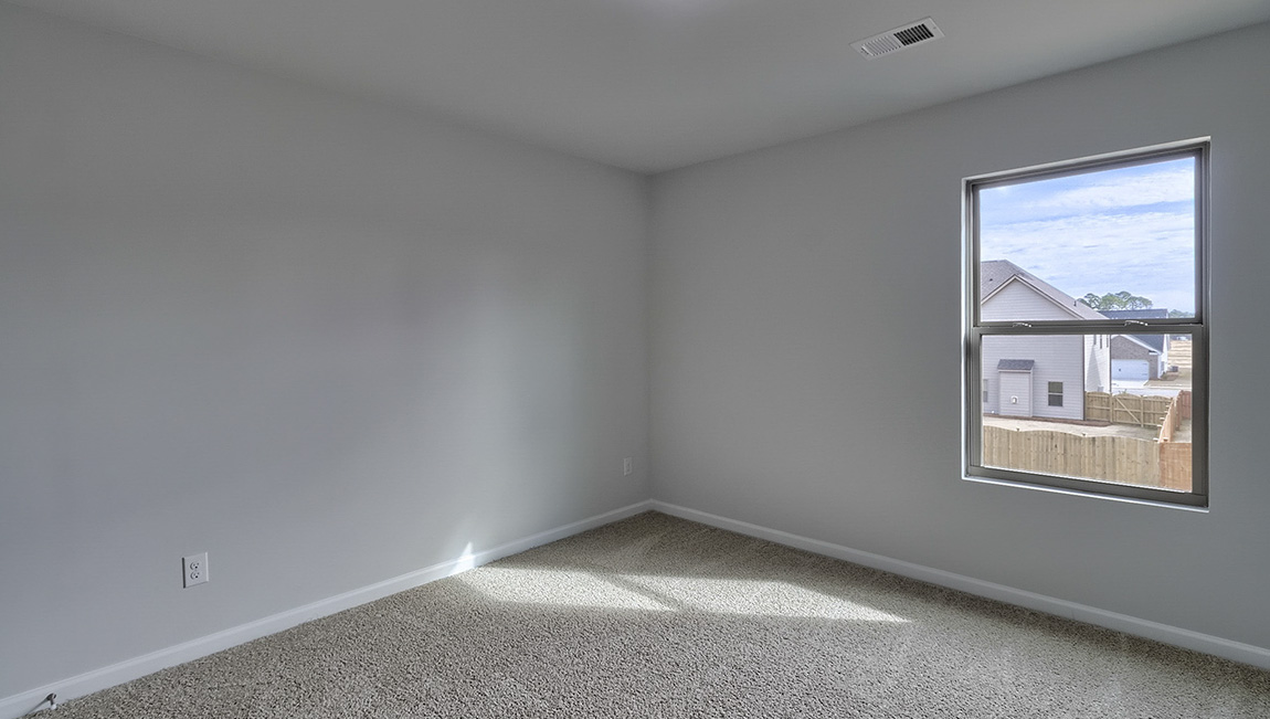 Carpeted bedroom with large window