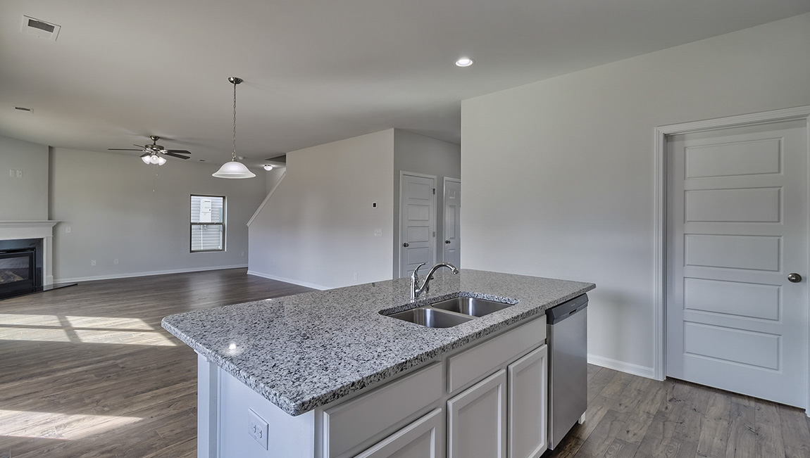 Kitchen and island with white cabinets and stainless steel appliances