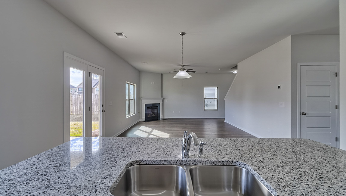 Kitchen and island with white cabinets and stainless steel appliances