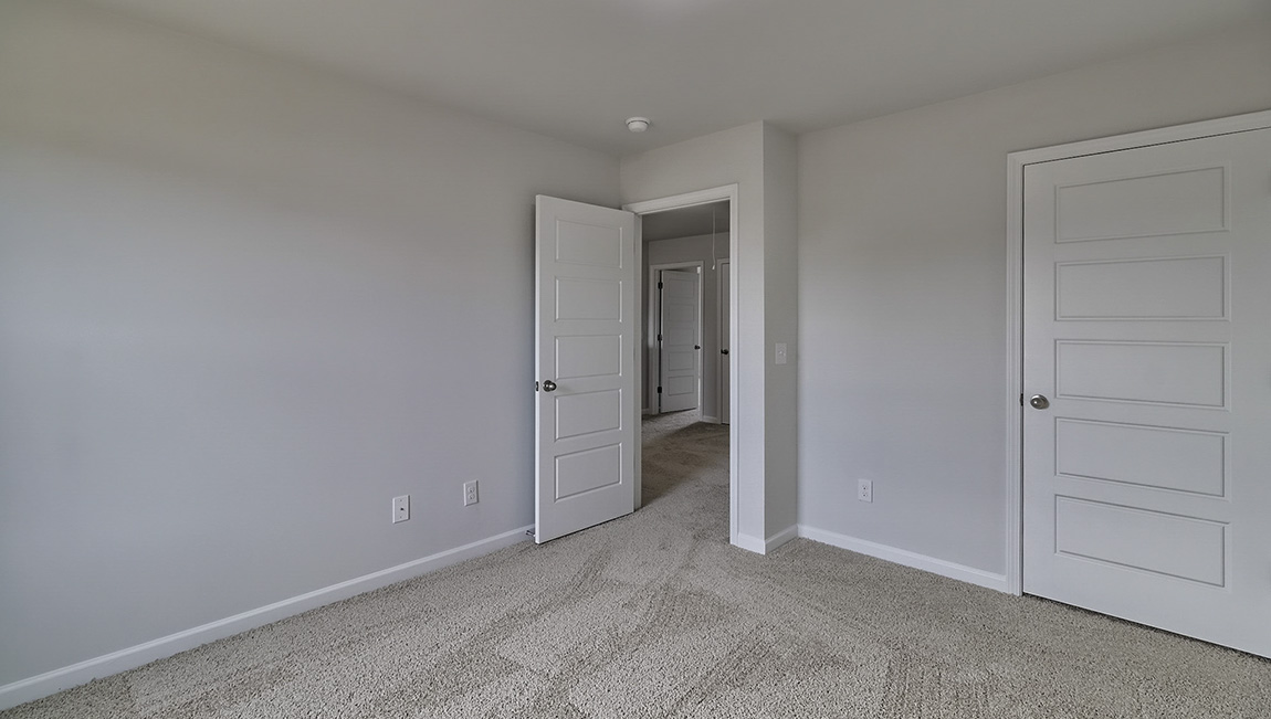 Carpeted bedroom with large window