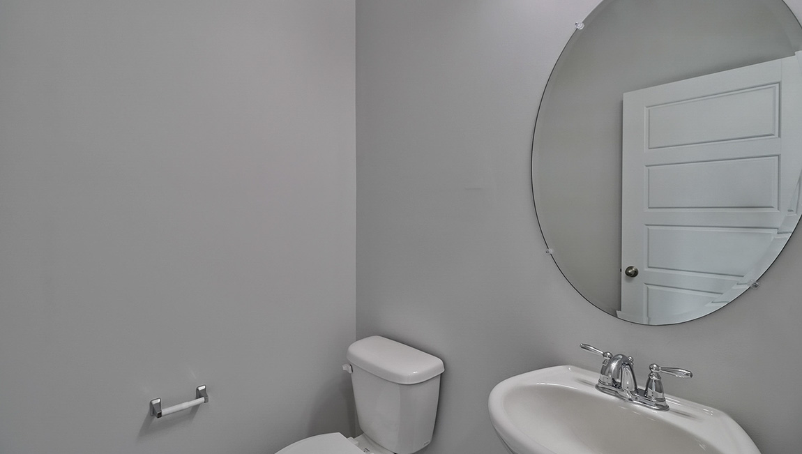 Powder bathroom with small sink and toilet