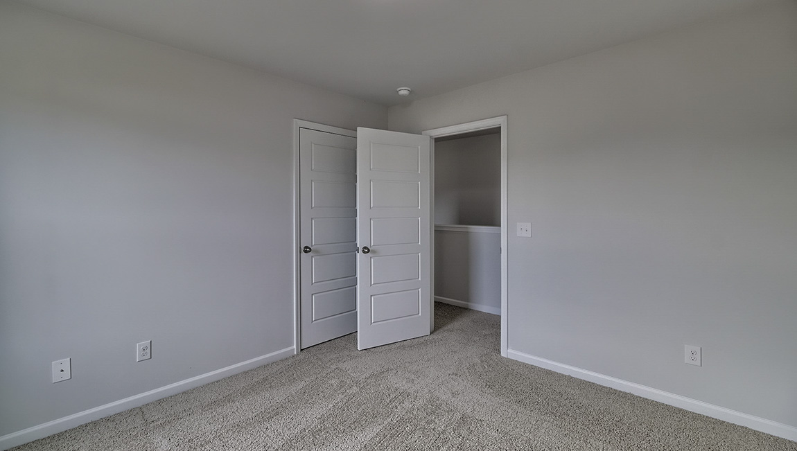 Carpeted bedroom with large window