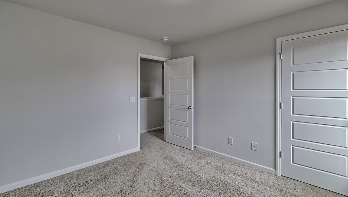 Carpeted bedroom with large window