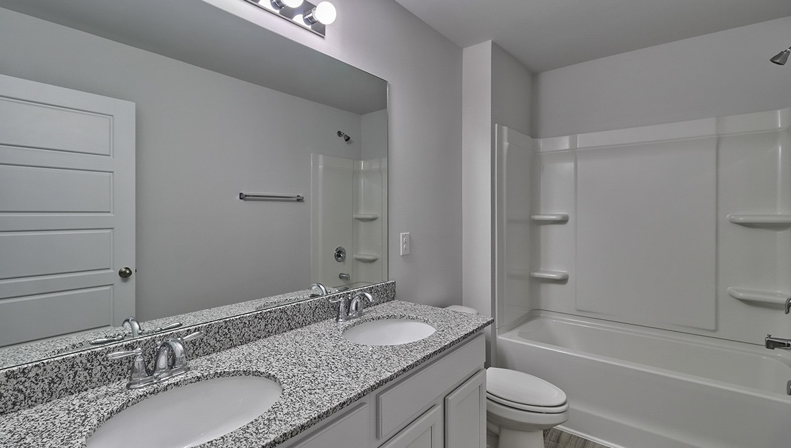 Bathroom with double sink vanity and bathtub shower combination