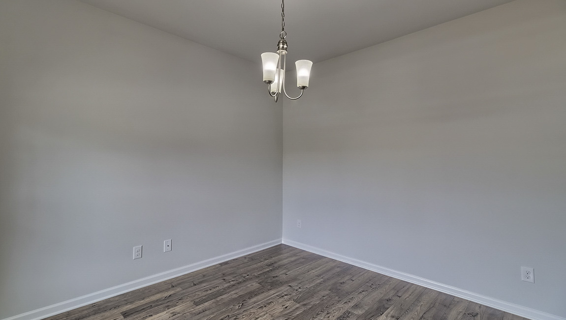 Dining room with vinyl floors and light figure on ceiling