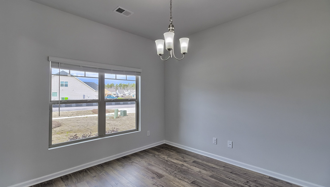 Dining room with vinyl floors and light figure on ceiling