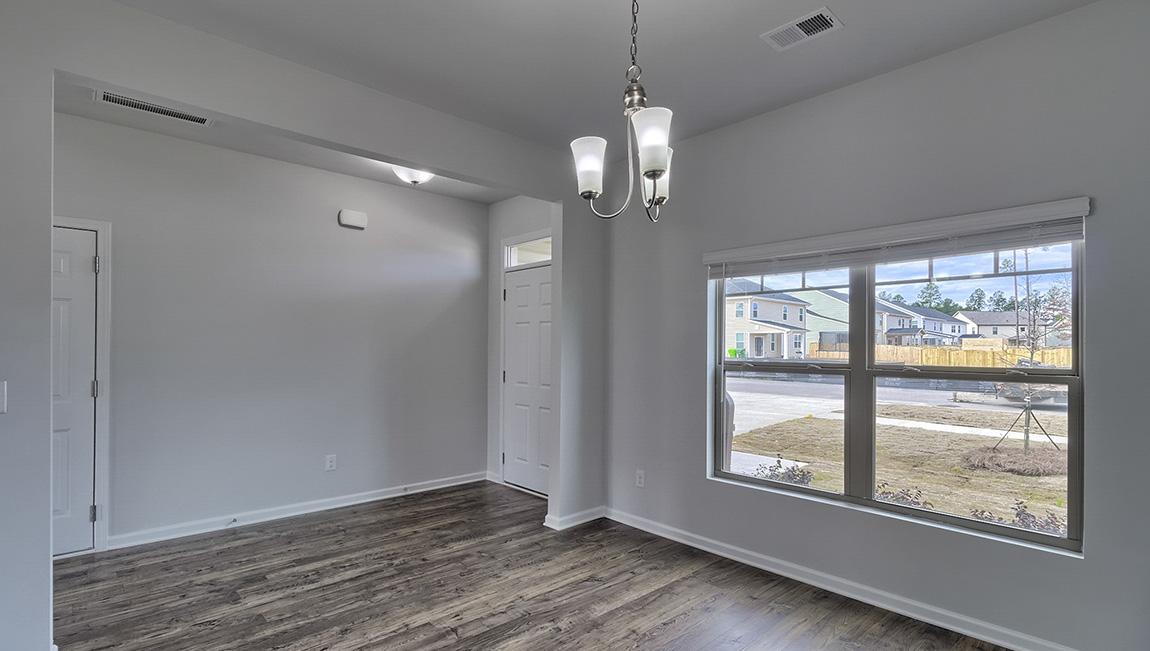 Dining room with vinyl floors and light figure on ceiling