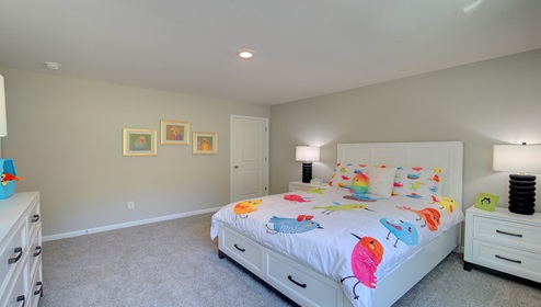Carpeted bedroom with large window