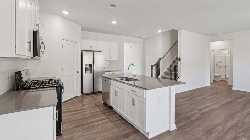 Open kitchen with island and stainless steel appliances