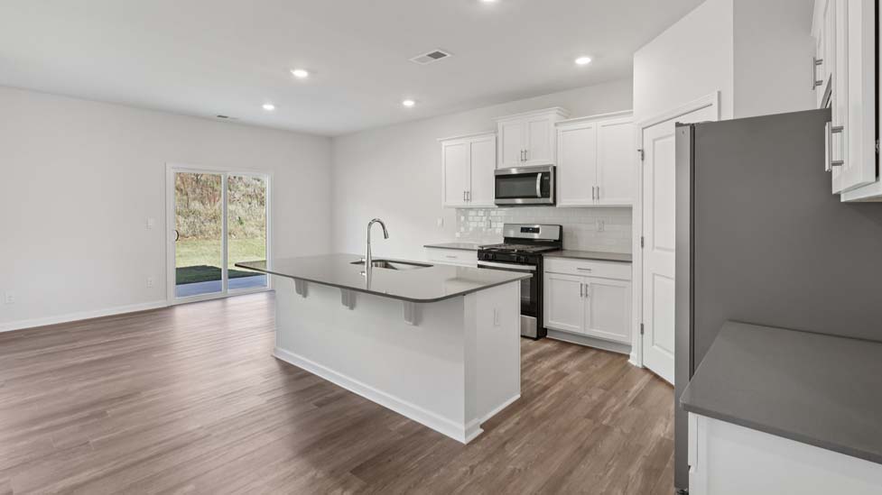 Open kitchen with island and stainless steel appliances