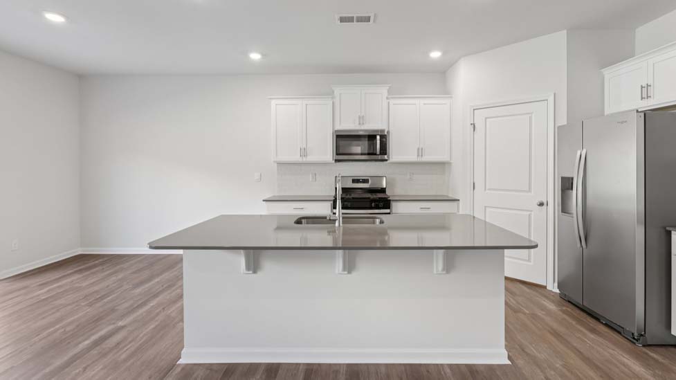 Open kitchen with island and stainless steel appliances