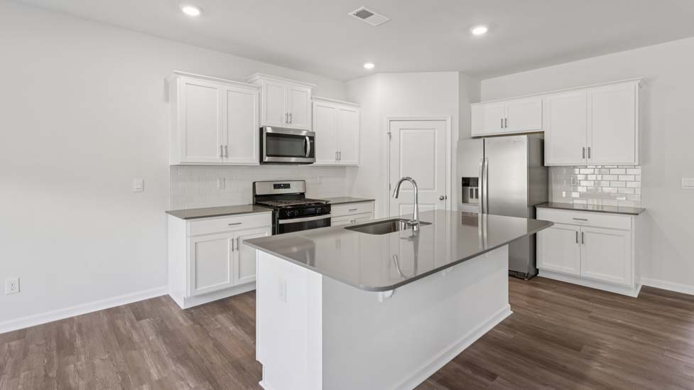 Open kitchen with island and stainless steel appliances
