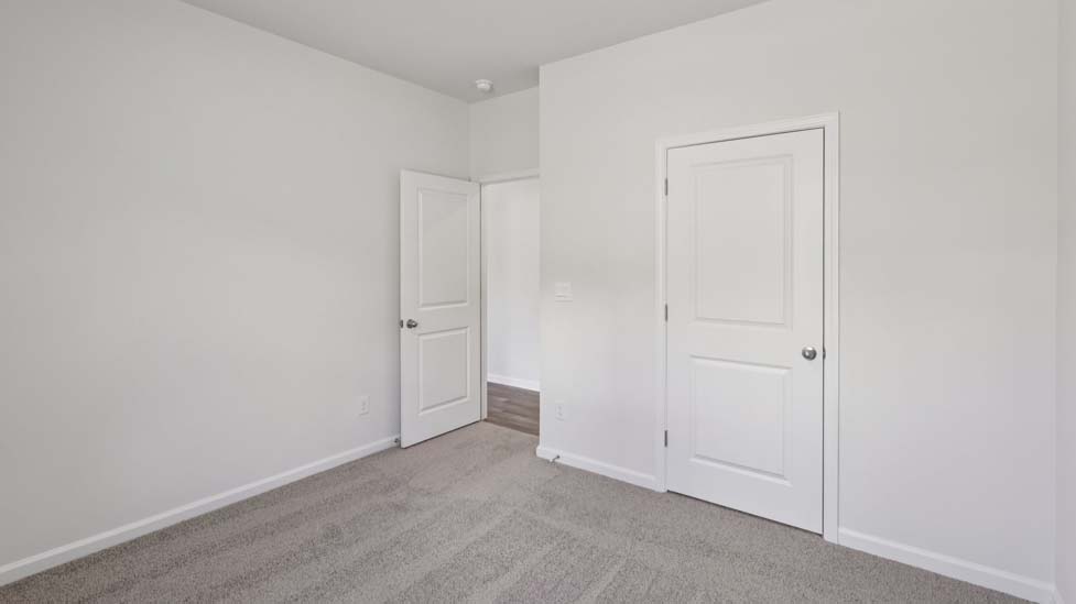 Carpeted bedroom with window