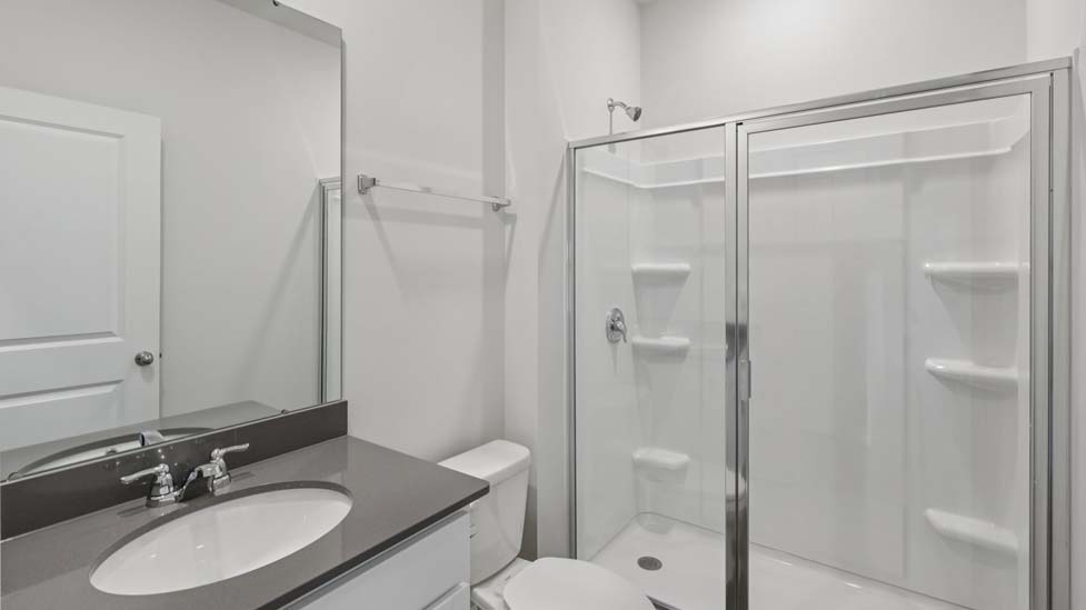 Bathroom with single vanity and walk in shower