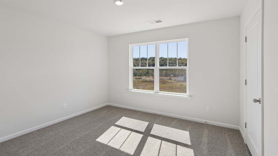 Carpeted bedroom with window