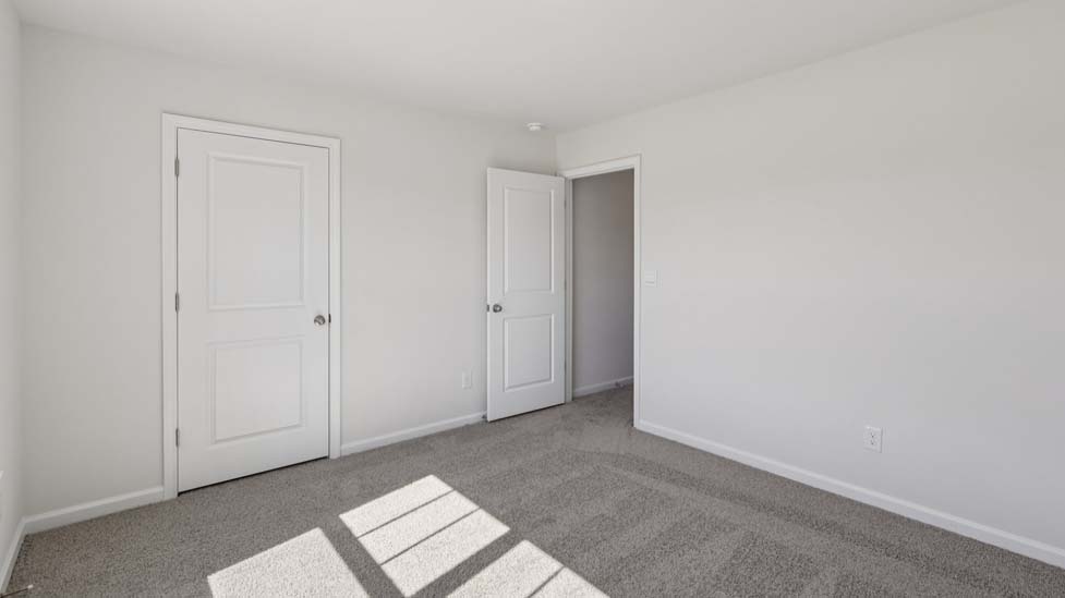 Carpeted bedroom with window