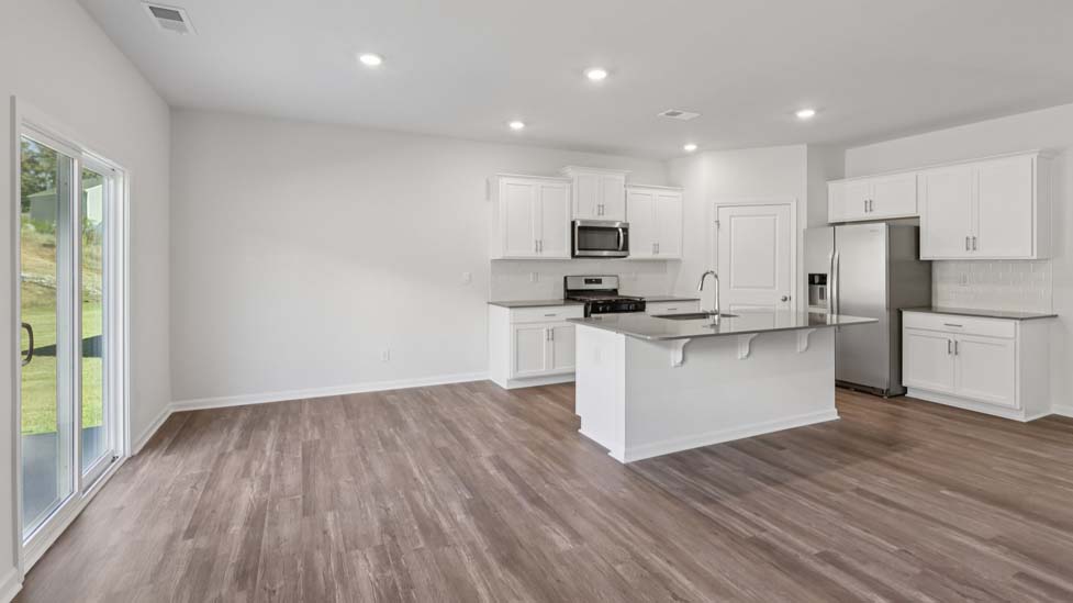 Open kitchen with island and stainless steel appliances