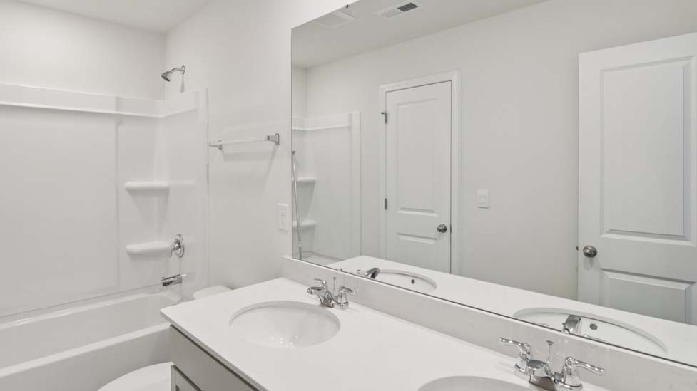 Bathroom with double vanity and bathtub