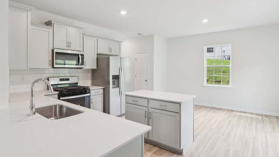 Open kitchen area with island and stainless steel appliances