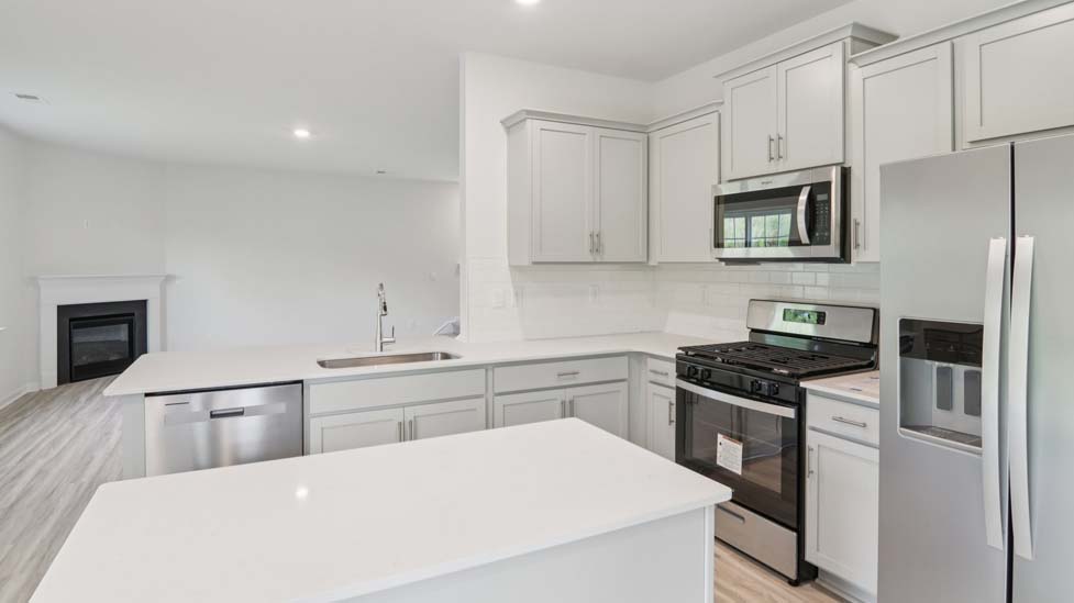Open kitchen area with island and stainless steel appliances