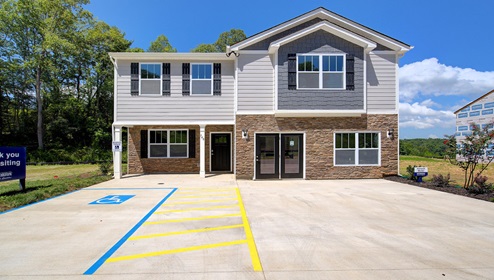 Rydele Heights Penwell model front exterior with stone, siding, and storefront