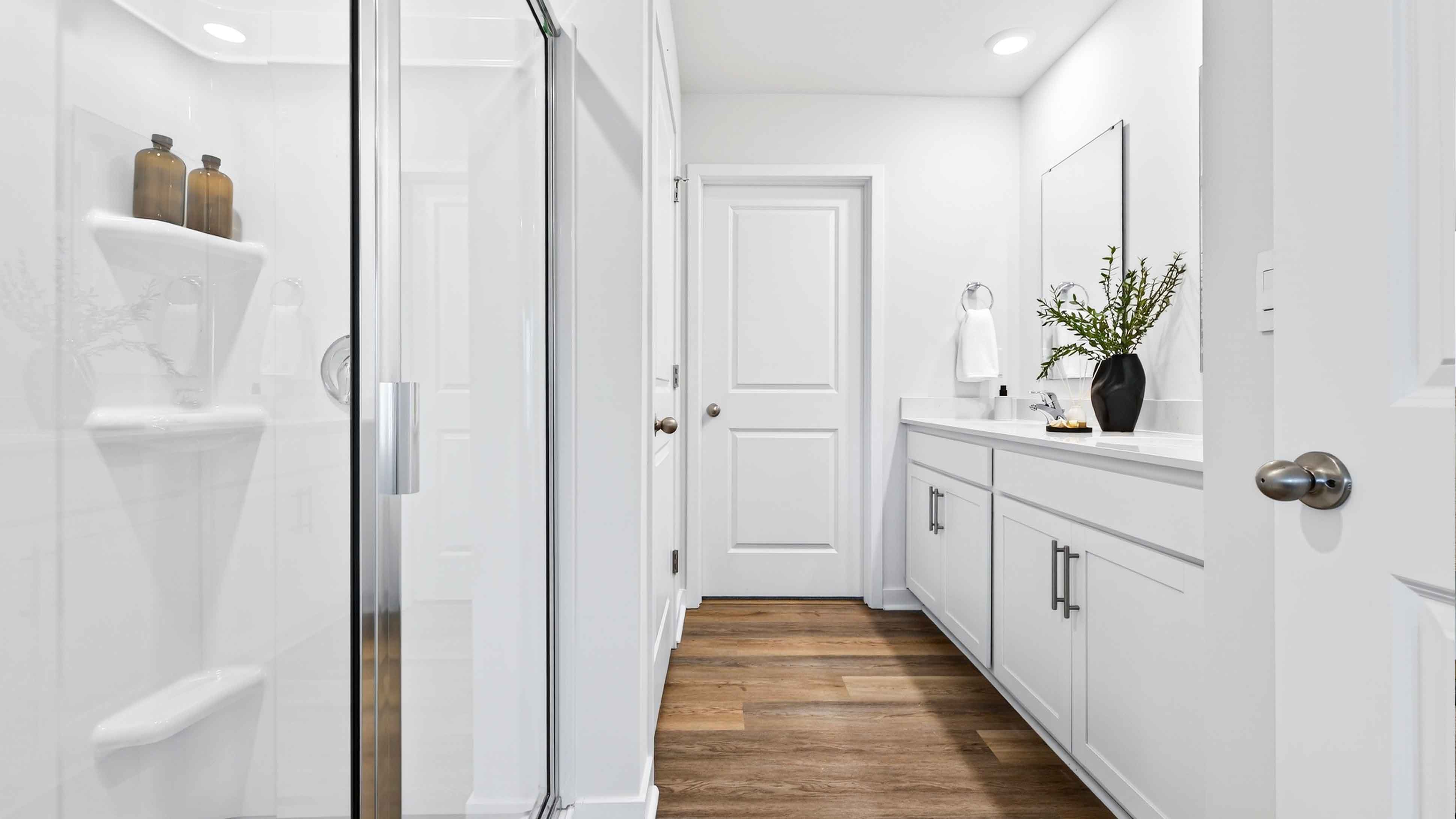 Primary bathroom with walk in shower and dual vanity