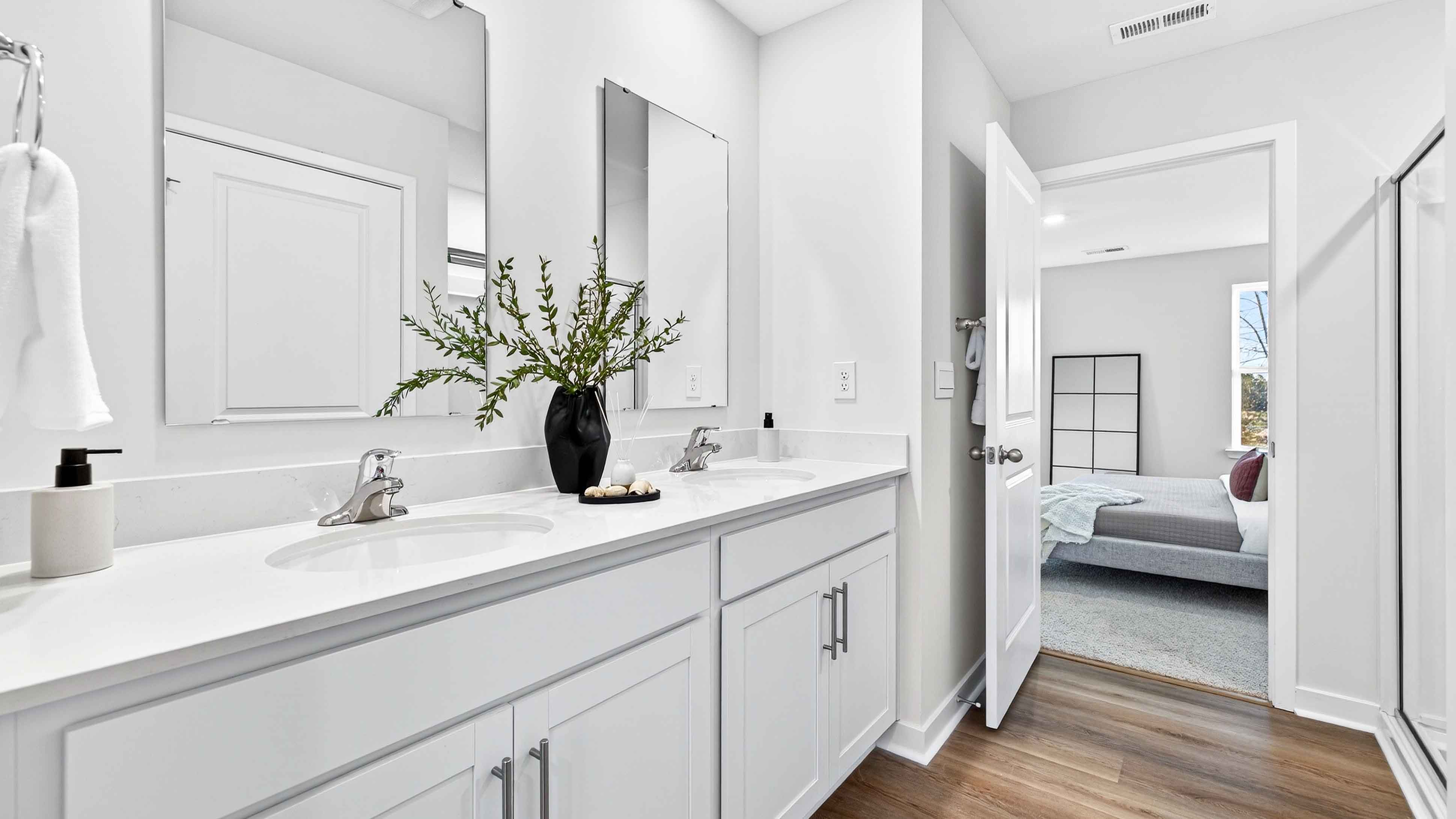 Primary bathroom with dual vanity and walk in shower