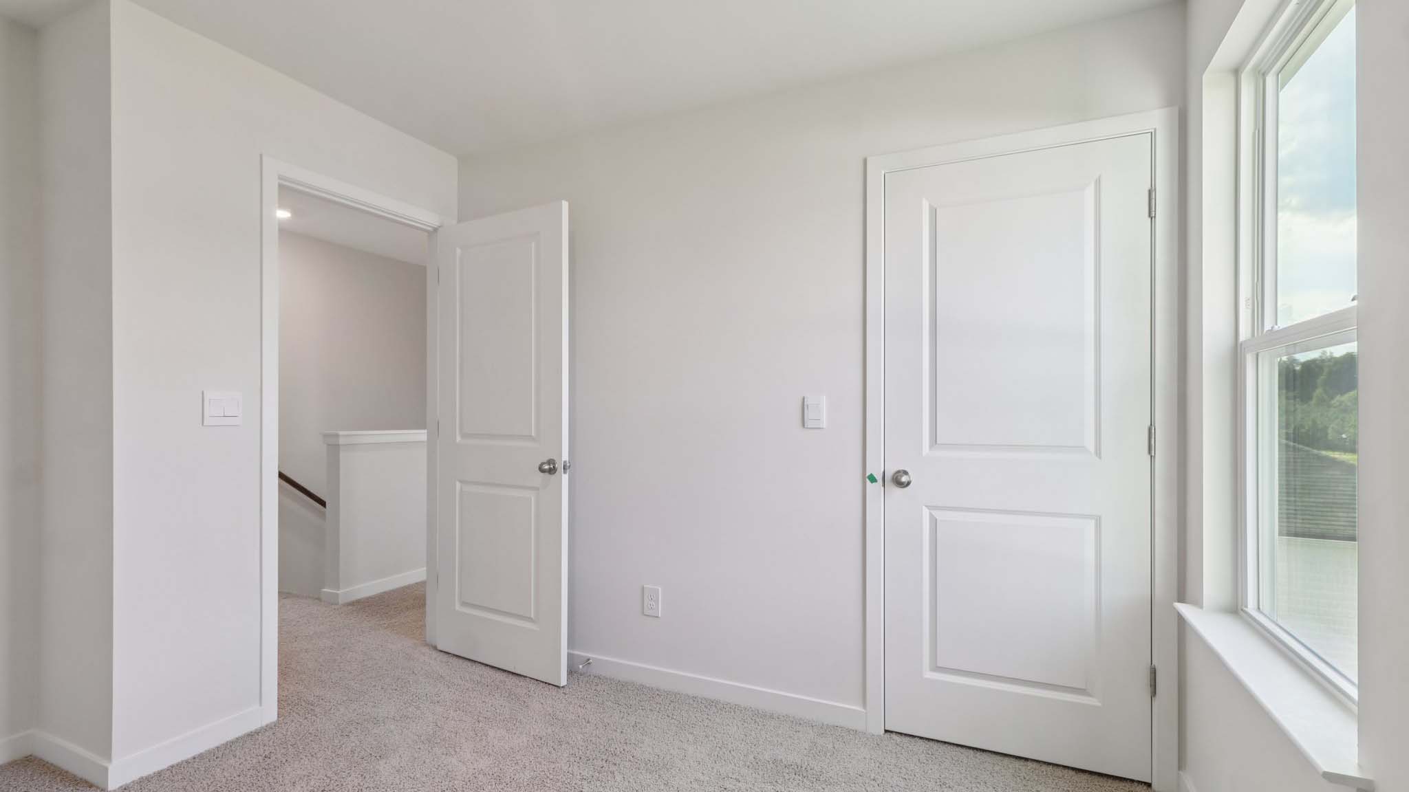Carpeted bedroom with large window