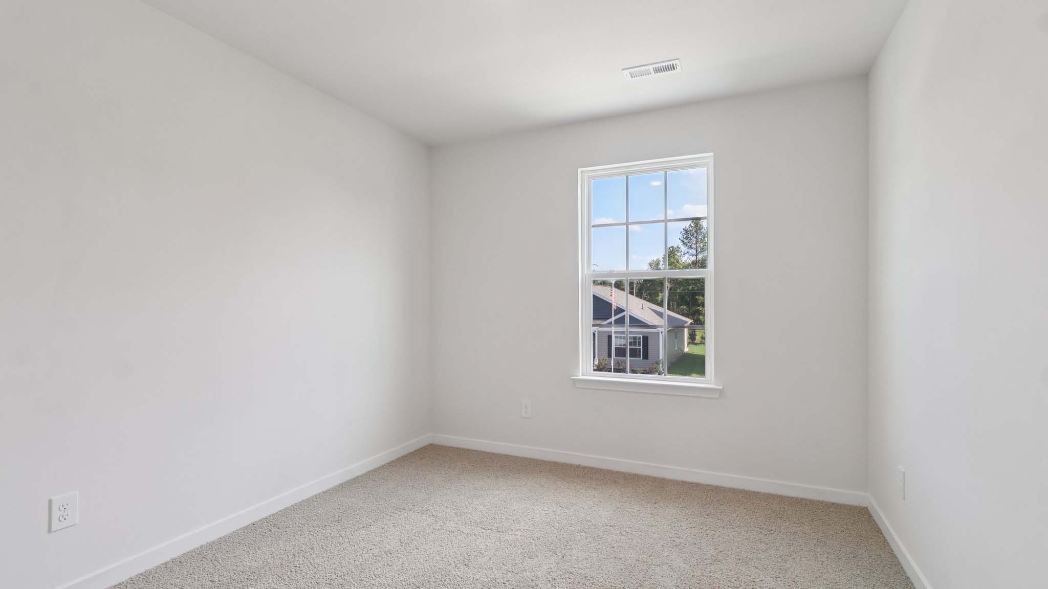 Carpeted bedroom with large window