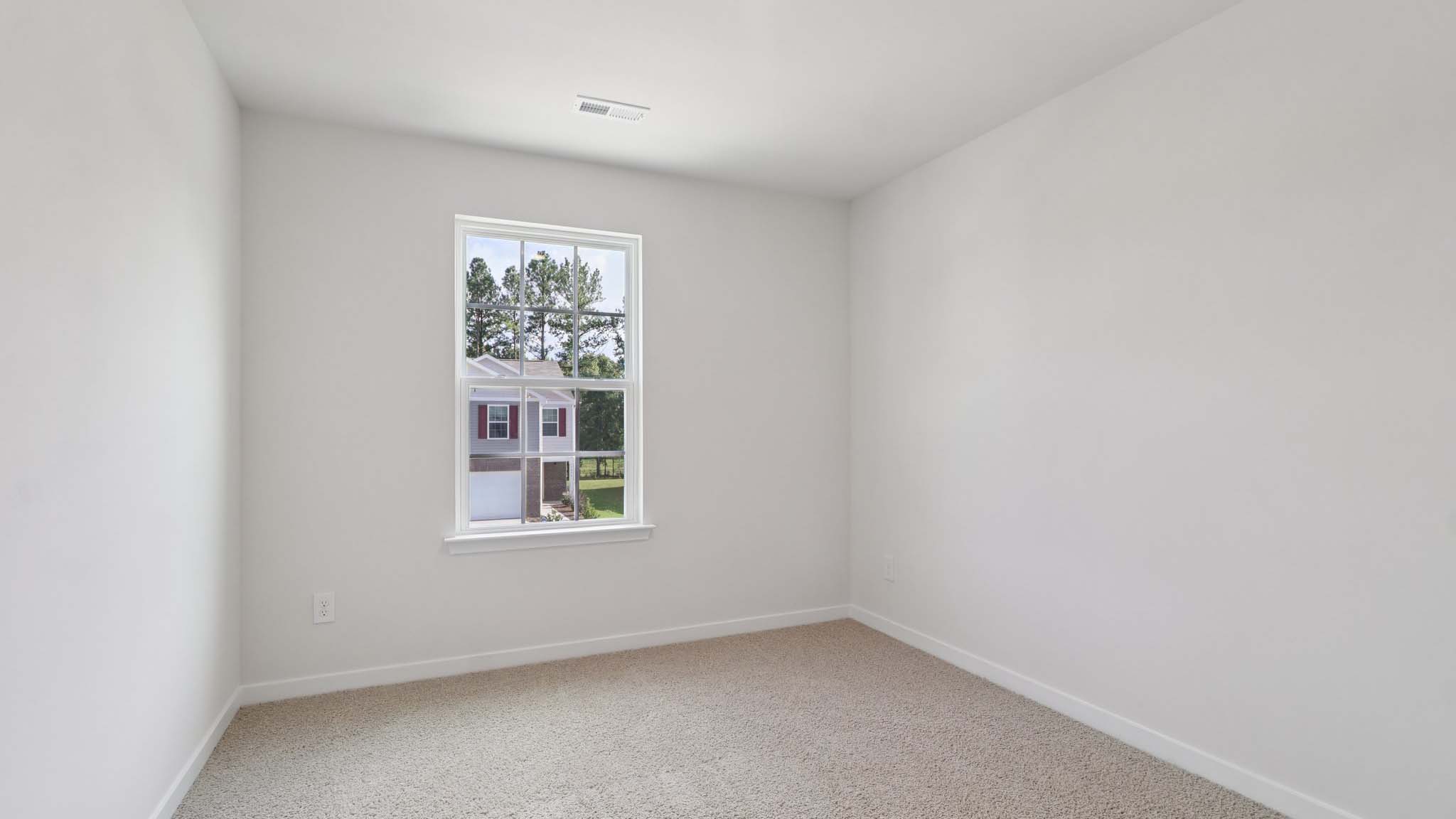 Carpeted bedroom with large window
