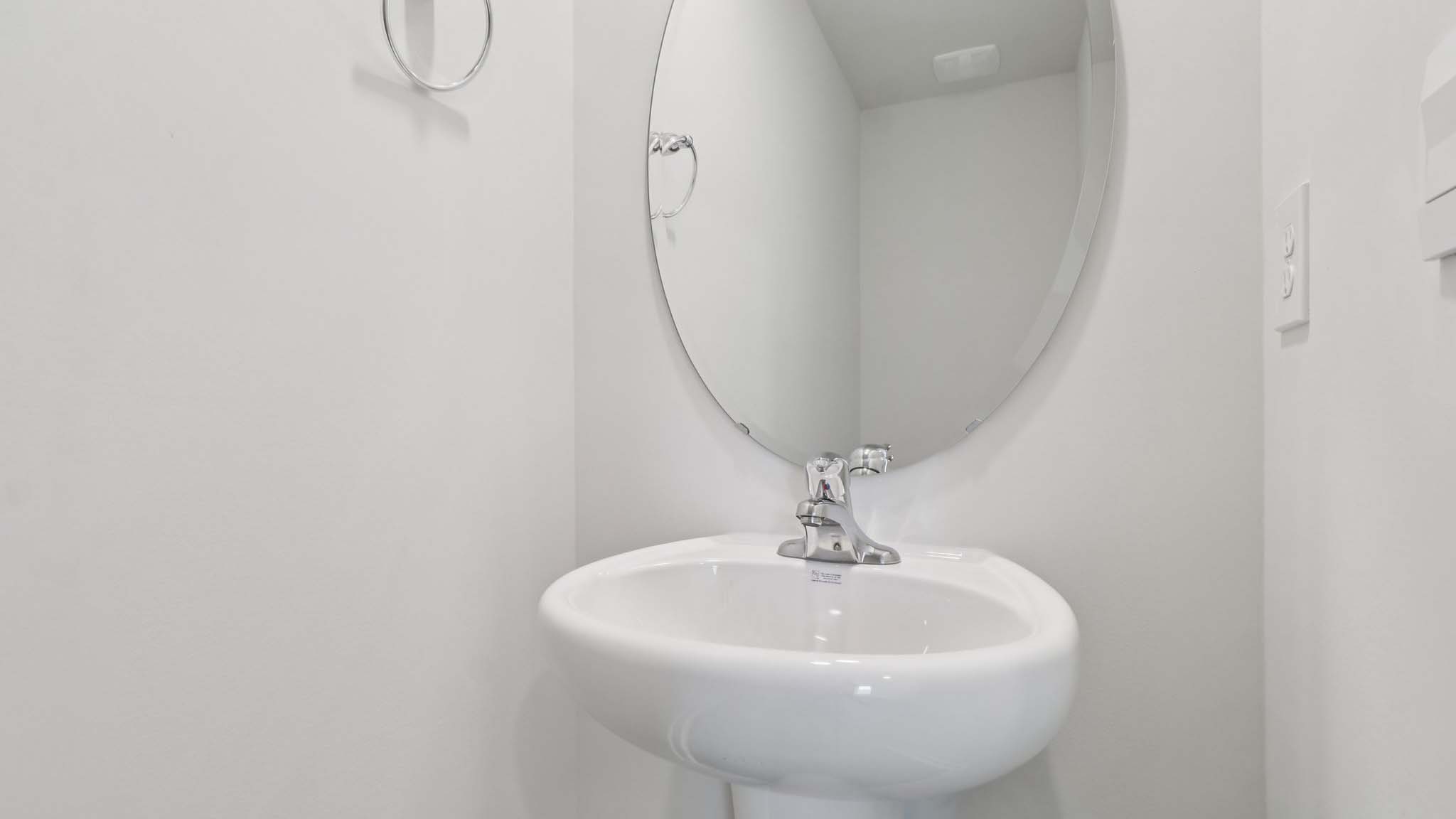 Half bathroom with single sink and mirror