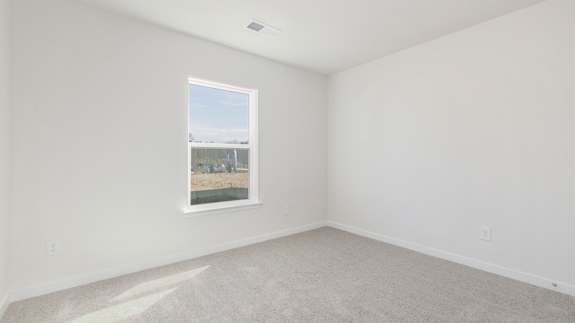 Carpeted bedroom with large windows