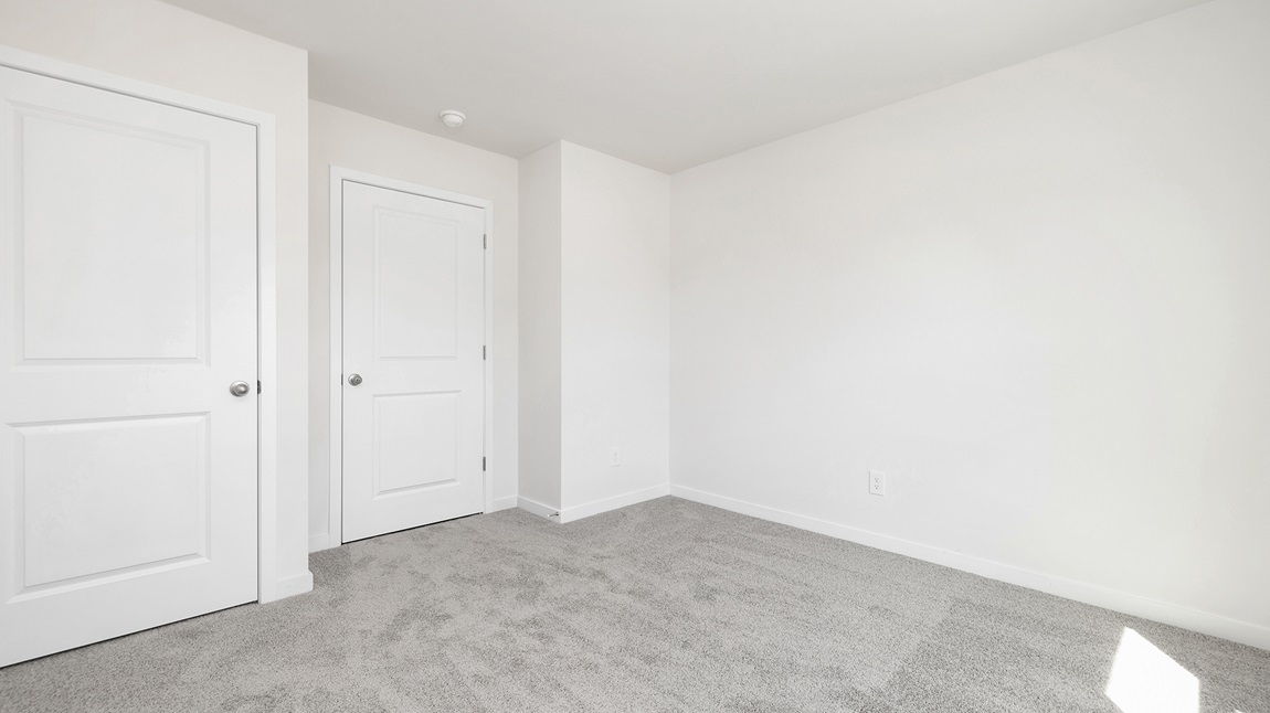 Carpeted bedroom with large windows