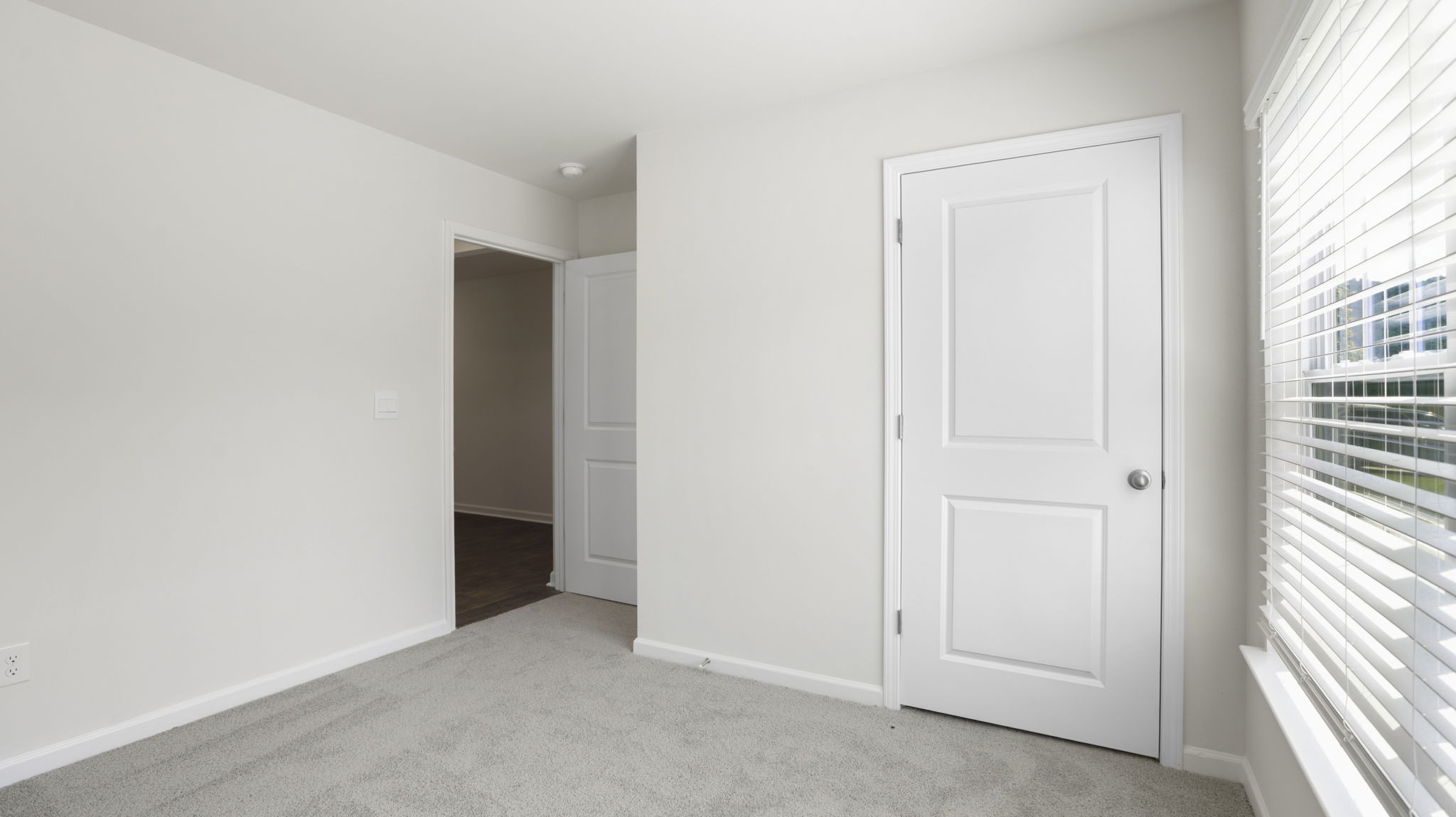 Carpeted bedroom with closet