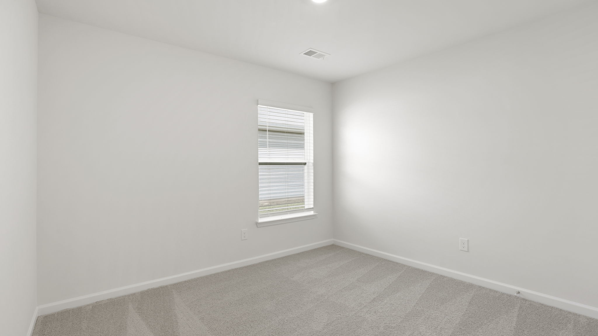 Carpeted bedroom with large windows
