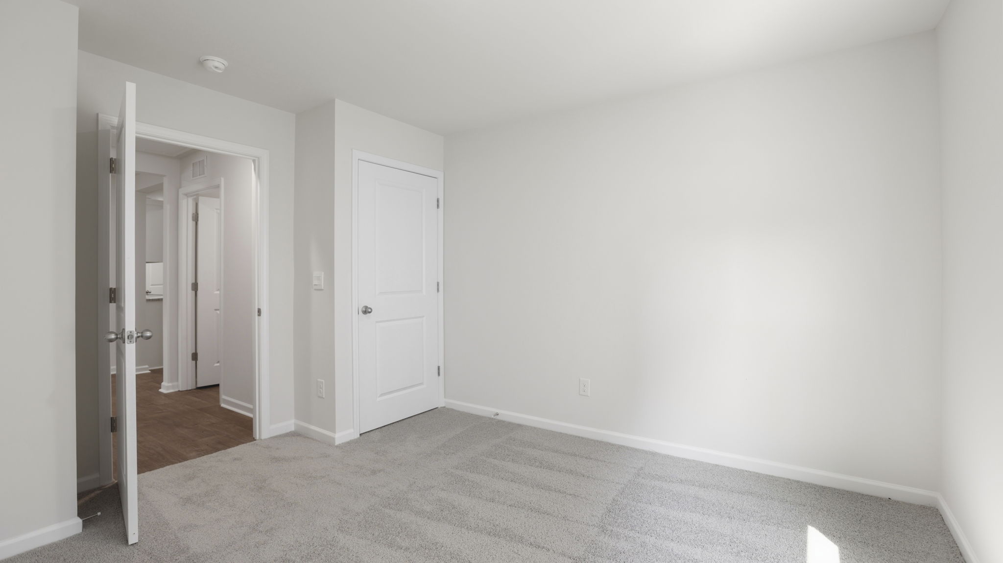 Carpeted bedroom with closet