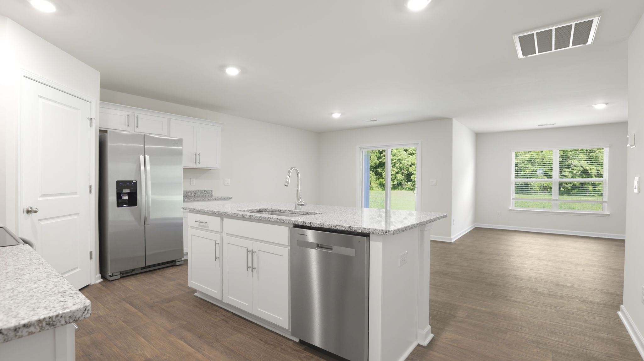 Open concept kitchen with stainless steel appliances and large island
