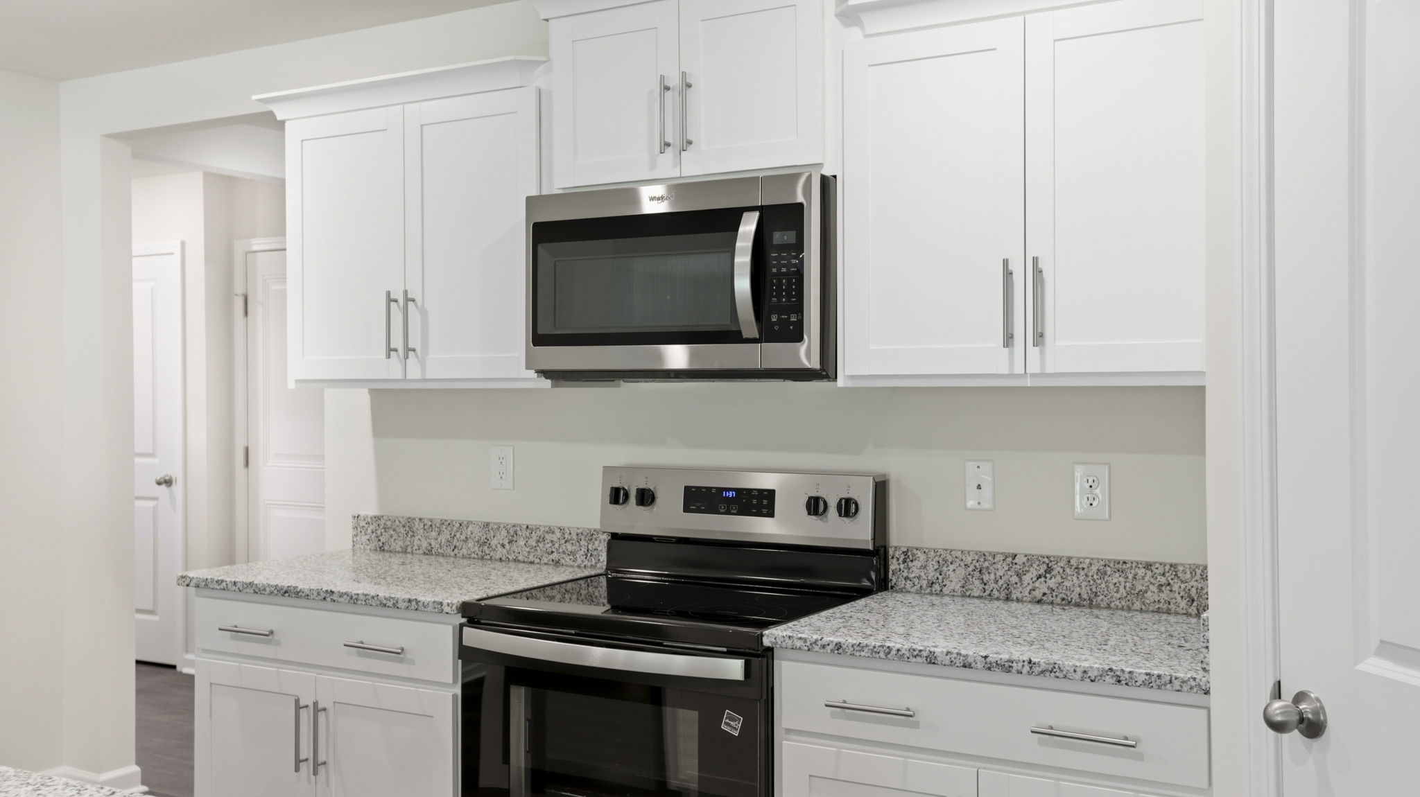 Open concept kitchen with stainless steel appliances and large island