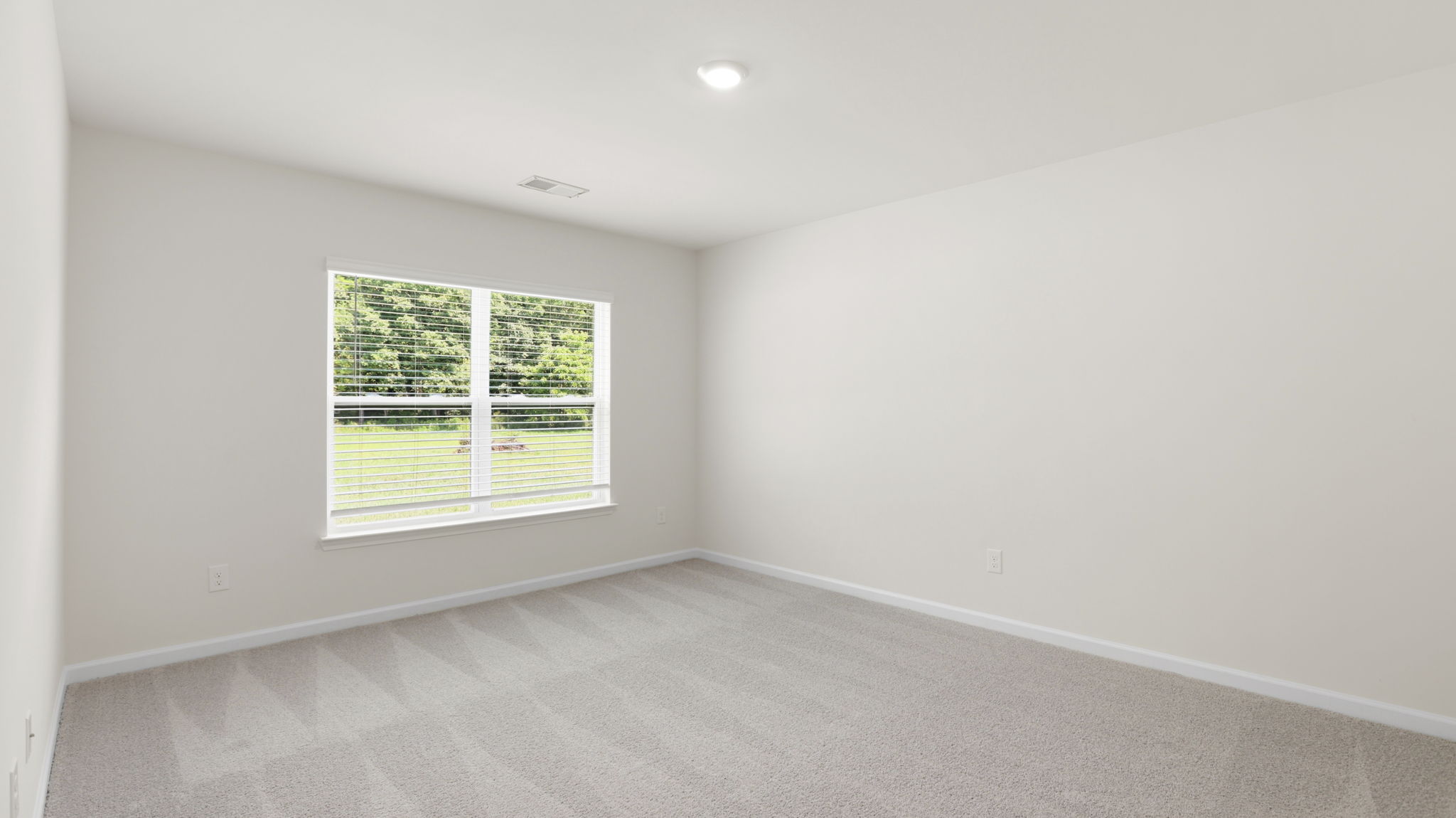 Carpeted bedroom with large windows