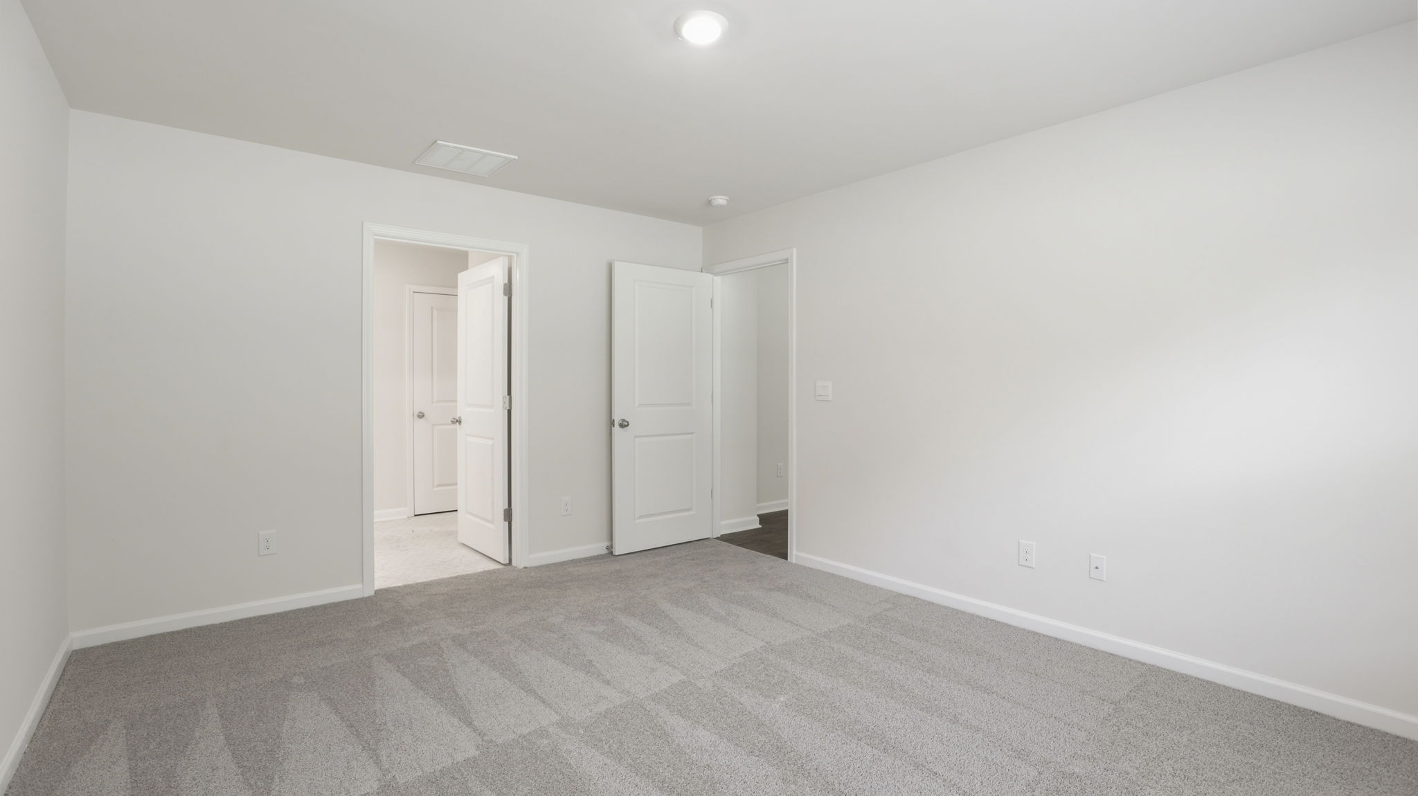Carpeted bedroom with closet