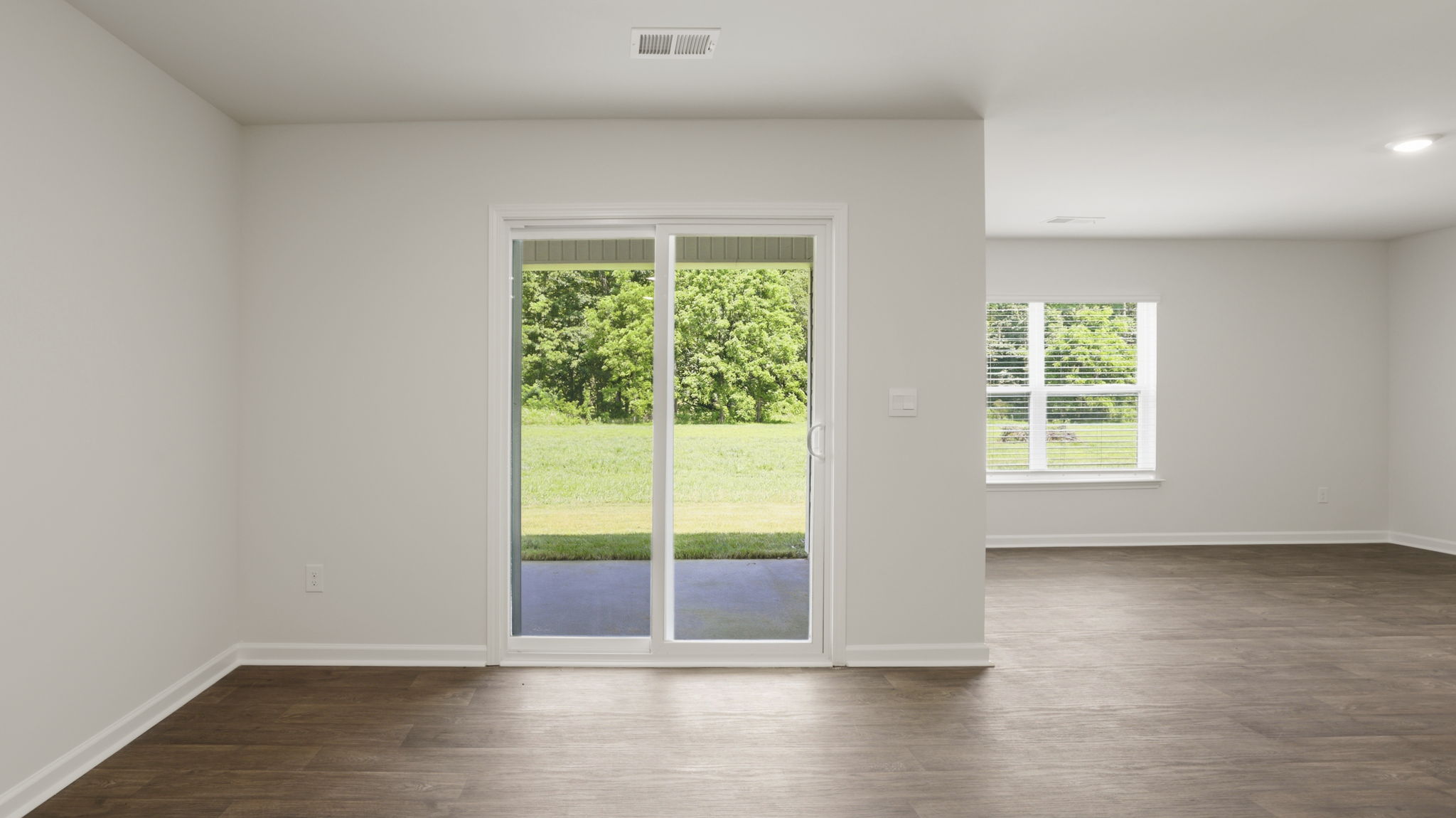 Open dining area with sliding glass doors to back patio