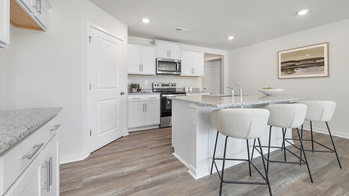 Open concept kitchen with large island, stainless steel appliances