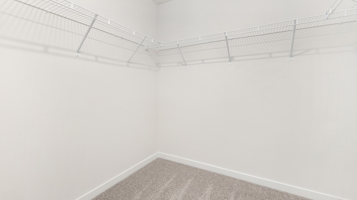Primary walk in closet with shelving
