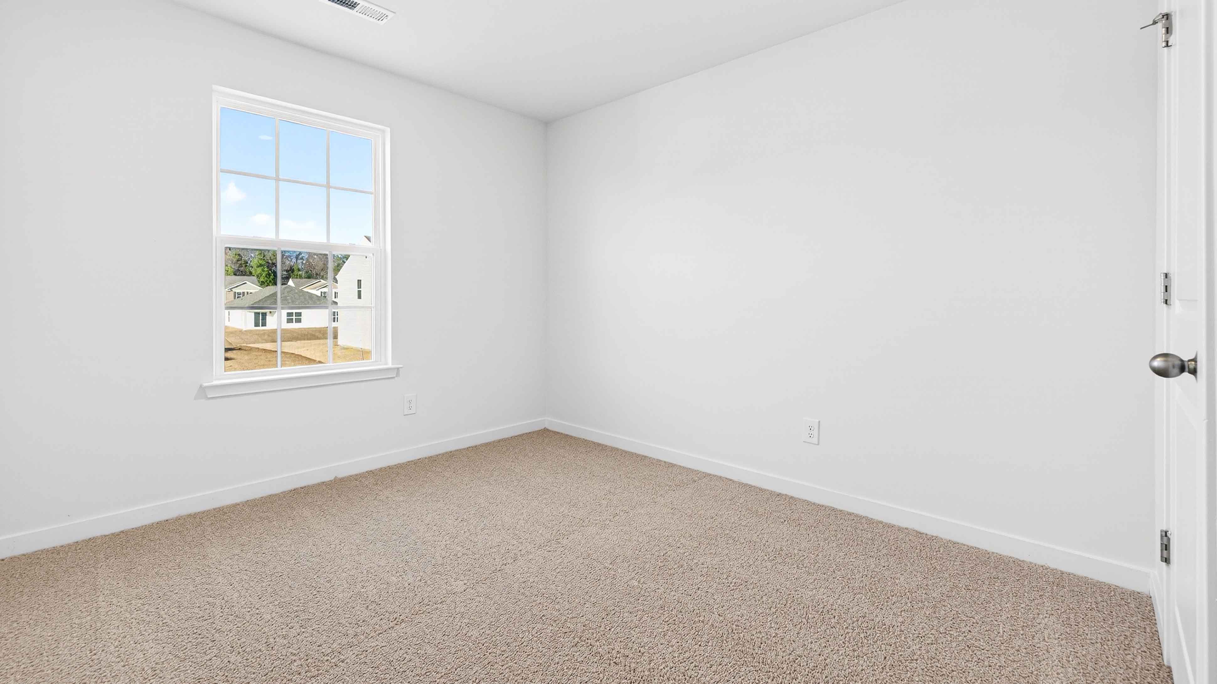 Carpeted bedroom with large window