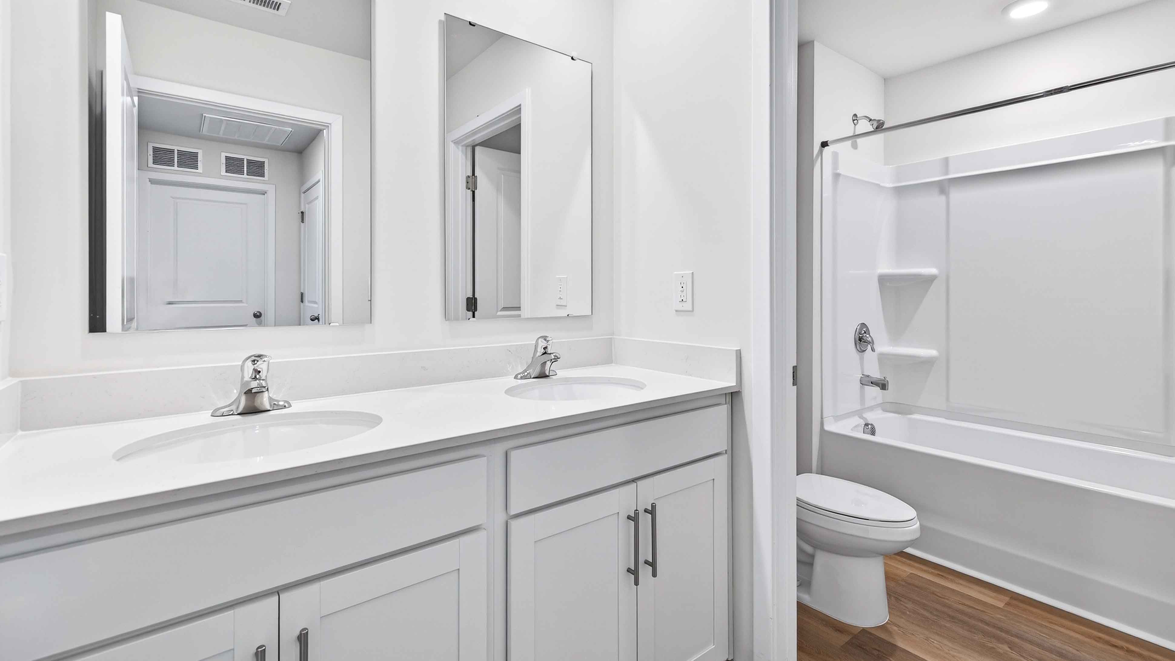 Bathroom with dual vanity and bathtub