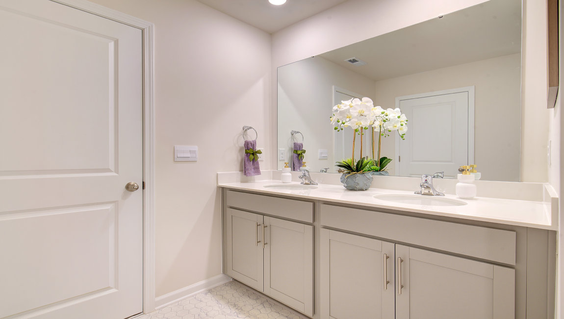 Primary bathroom with dual vanity and walk in shower