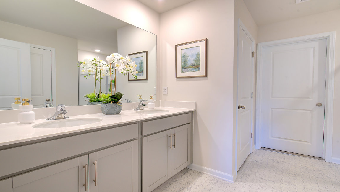 Primary bathroom with dual vanity and walk in shower