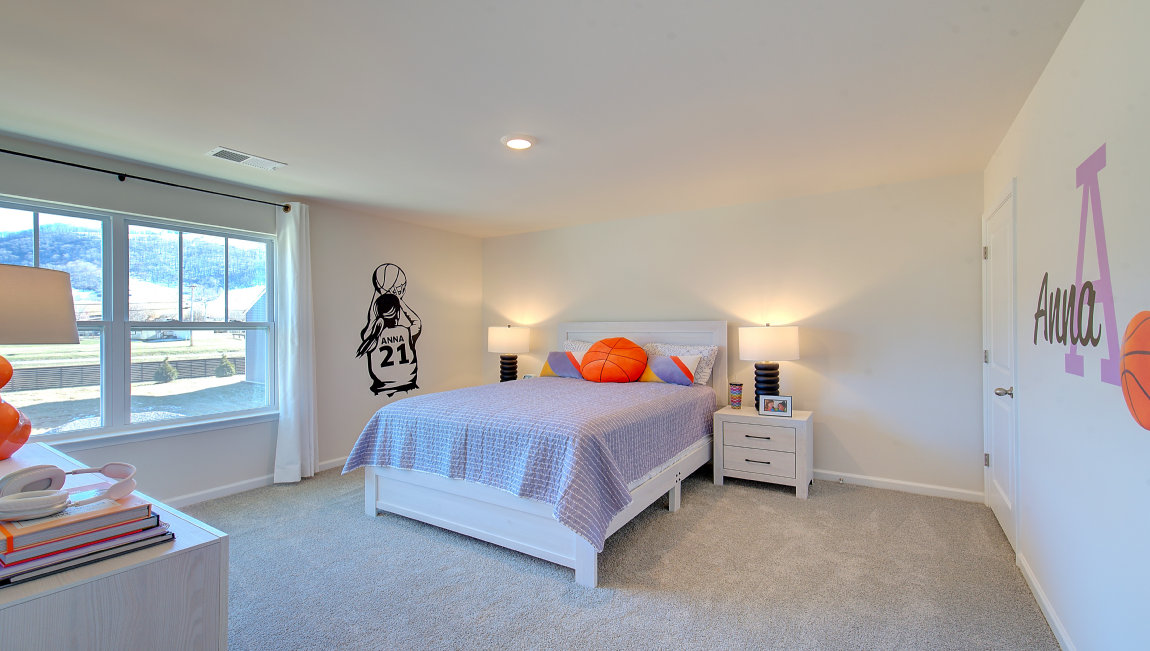 Carpeted bedroom with large windows